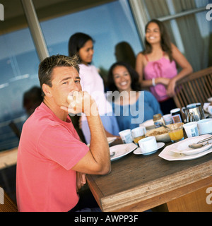 Family having breakfast, focus on father Stock Photo
