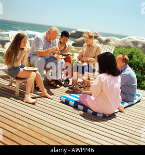 Multi-generation family eating outside Stock Photo