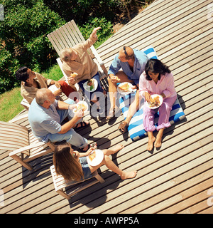 Grandparents, parents and children eating outside, elevated view Stock Photo