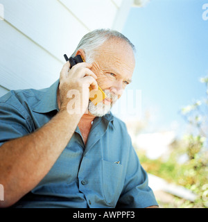 Mature man using cell phone, outside Stock Photo