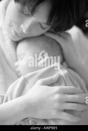Mother holding sleeping infant, b&w Stock Photo