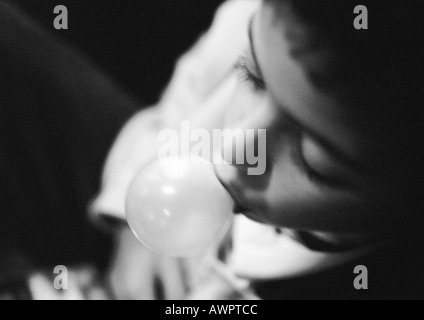 Young child blowing bubble, b&w. Stock Photo