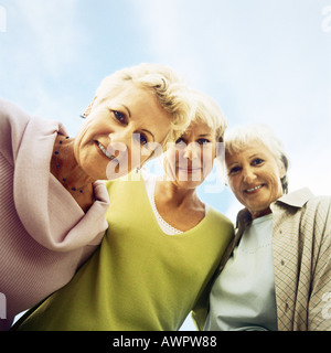 Three mature women, looking at camera, low angle view Stock Photo
