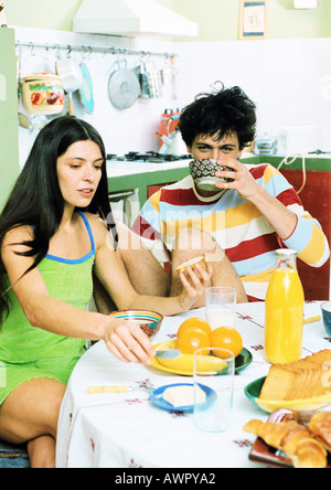 Young couple sitting at table having breakfast. Stock Photo