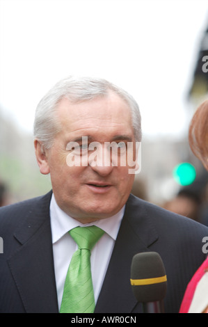 An Taoiseach (Prime Minister) Bertie Ahern talks to a reporter at the St Patrick's Day parade wearing a green tie Stock Photo