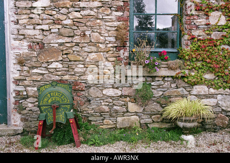 Turnip Grinder in front of old building near Aughrim Co Wicklow Ireland Stock Photo