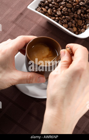 Stirring coffee Stock Photo