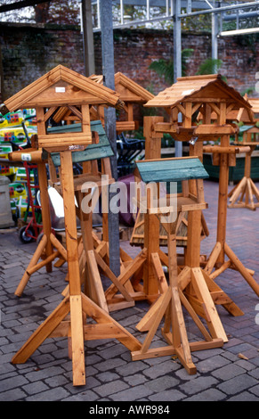 UK Wooden bird feeding station mounted on wooden post. Covered wooden ...