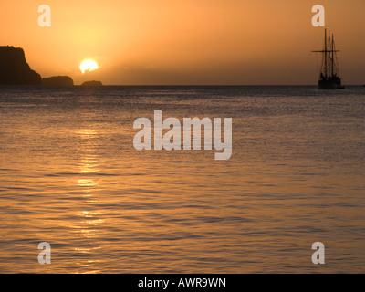 Caribbean Sunset over Admiralty Bay, Port Elizabeth, Bequia and square rigger ship in the background Stock Photo