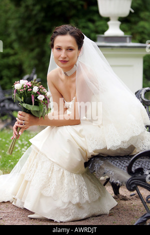 Smiling bride in traditional white wedding dress Stock Photo