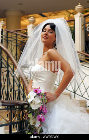 Smiling bride in traditional white wedding dress Stock Photo