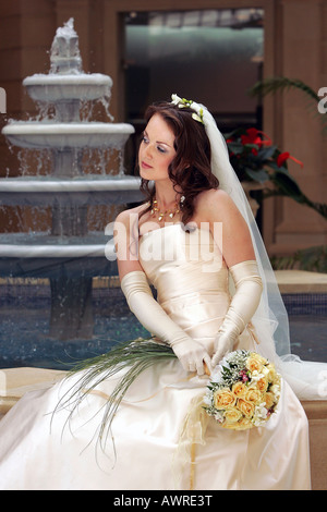 Smiling bride in traditional white wedding dress Stock Photo