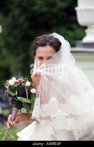 Smiling bride in traditional white wedding dress Stock Photo