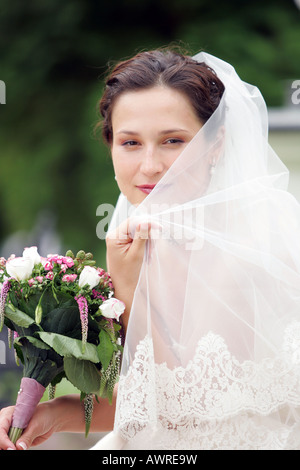 Smiling bride in traditional white wedding dress Stock Photo
