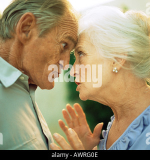 Senior man and woman having argument, side view Stock Photo