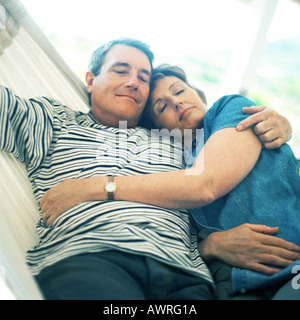 Mature couple lying in hammock Stock Photo