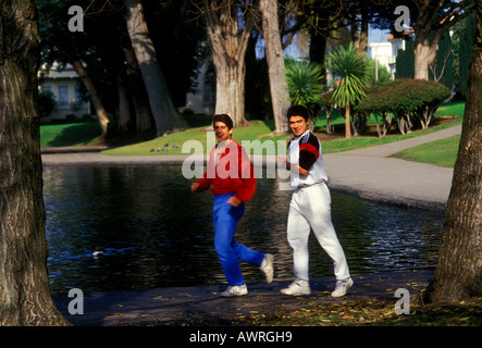 2 two Hispanic boys teenagers teenage boys friends joggers jogging at Palace of Fine Arts in San Francisco, California, United States, North America Stock Photo