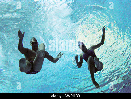 Couple swimming underwater, underwater view. Stock Photo