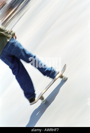 Young man on skateboard, low section. Stock Photo