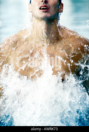 Man emerging from water, close-up Stock Photo