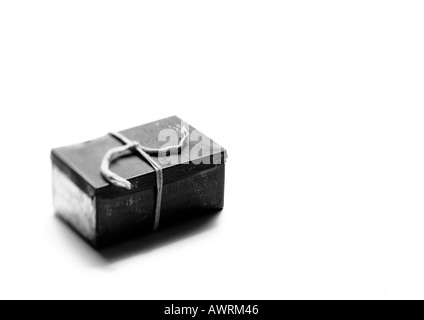 Metal box tied with string, b&w. Stock Photo