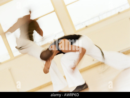 Two men performing capoeira, blurred Stock Photo