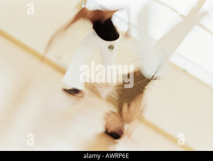 Two men performing capoeira, blurred Stock Photo