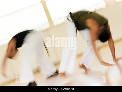 Two men performing capoeira, blurred Stock Photo