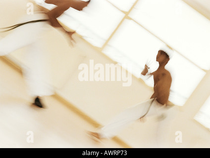 Two men performing capoeira, blurred Stock Photo