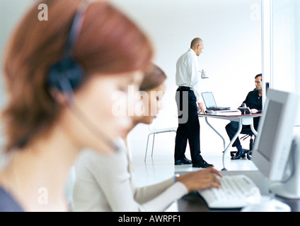 Business people in office, blurred foreground Stock Photo