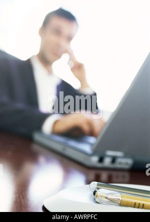 Businessman using laptop computer, blurred Stock Photo