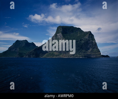 Looking across Pacific Ocean to majestic cliffs of green forested Lord Howe Island in the South Pacific
