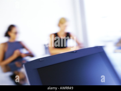 Women sitting at desk, blurred Stock Photo