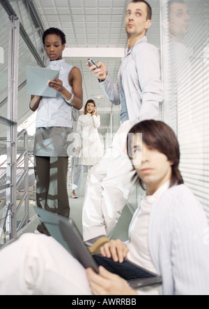 Business people working in office hallway Stock Photo
