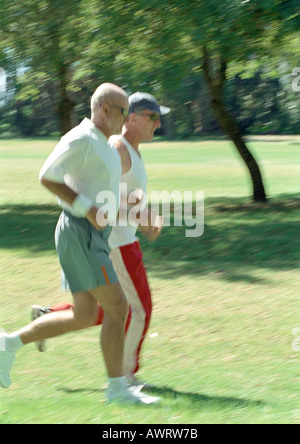 Two mature joggers in park, side view Stock Photo