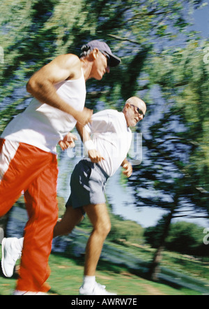 Two mature joggers in park, low angle view Stock Photo