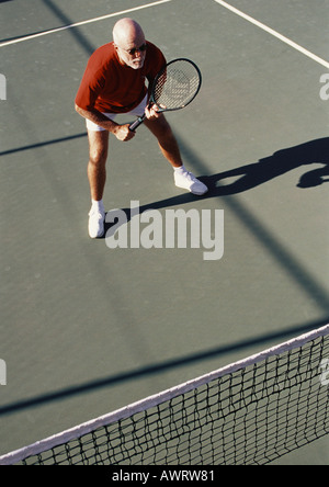 Mature man playing tennis Stock Photo