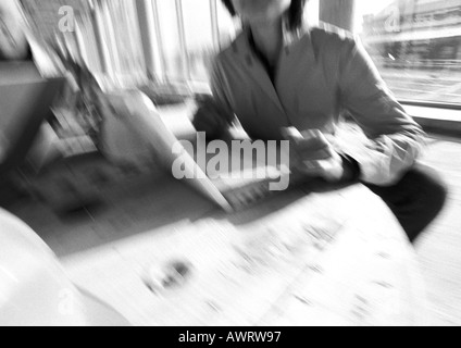 Woman using laptop computer, blurred, b&w Stock Photo
