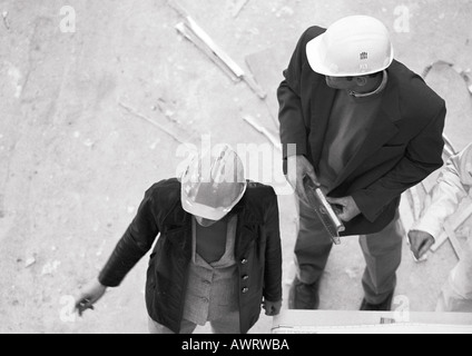 Two people wearing hard hats, elevated view, b&w Stock Photo