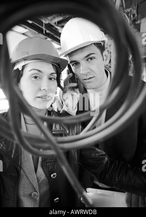 Man and woman wearing hard hats, portrait, b&w Stock Photo