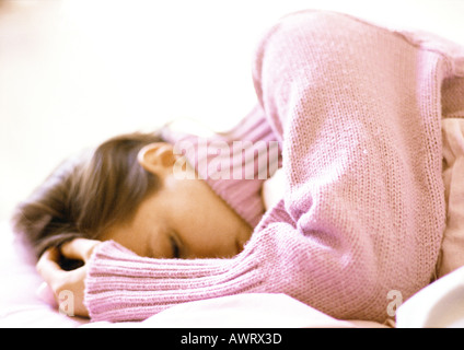 Woman lying with hand on head, close-up Stock Photo