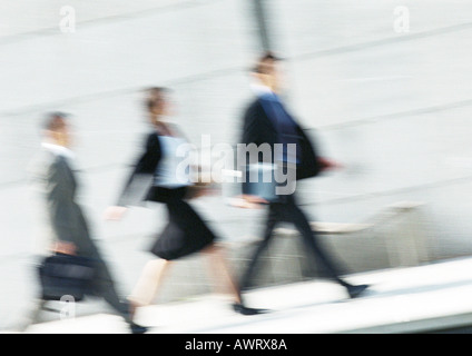 Business people walking in street, full length, tilt, blurred Stock Photo