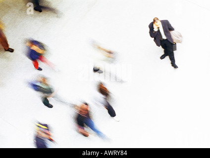 Businessman in crowd, elevated view, blurred Stock Photo