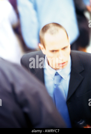 Businessman in crowd, close-up, elevated view Stock Photo