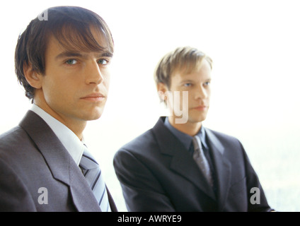 Businessmen sitting next to each other Stock Photo