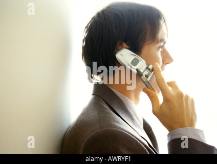 Businessman on cell phone, side view, head and shoulders Stock Photo