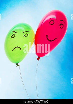 Two balloons with a funny and an angry face Stock Photo