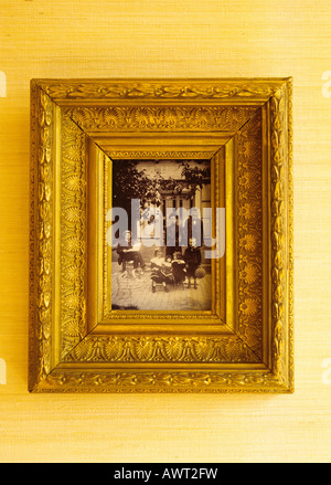 1905's vintage photo of a family in a golden frame Stock Photo