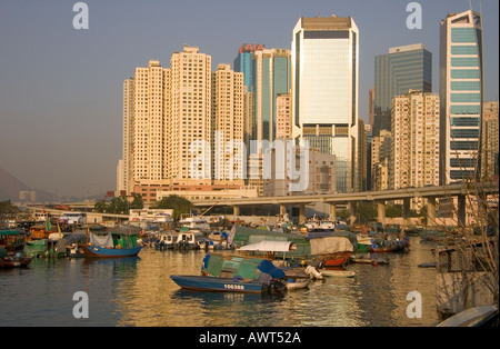 dh Typhoon shelter CAUSEWAY BAY HONG KONG Junk house boats below Eastern corridor and skyscraper buildings boat Stock Photo