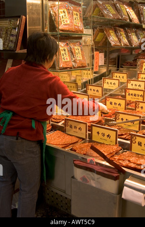 dh  MACAU CHINA Shopkeeper at Chinese snack stall display shop dried meat